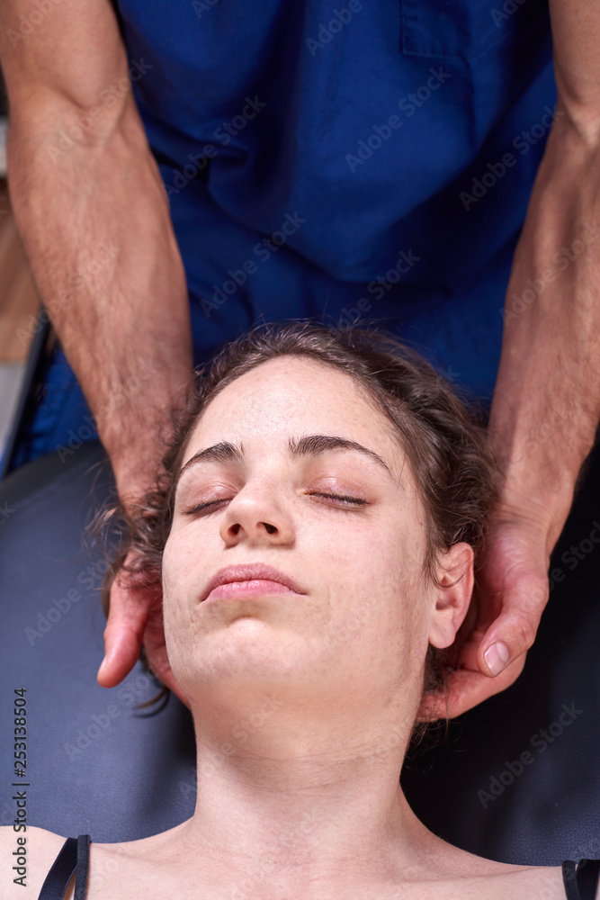 Fototapeta premium Chiropractic getting mobilization cervical spine of a woman. Manual therapy. Neurological physical examination. Osteopathy, physiotherapist