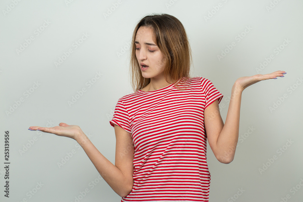 Emotional portrait of a fair-haired girl on a gray background, stormy emotions, business concept. Emotional portrait of a fair-haired girl on a gray background, stormy emotions, business concept.