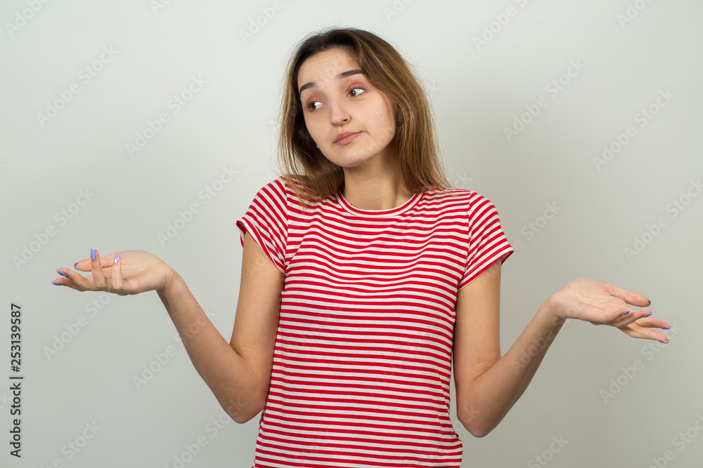 Emotional portrait of a fair-haired girl on a gray background, stormy emotions, business concept. Emotional portrait of a fair-haired girl on a gray background, stormy emotions, business concept.