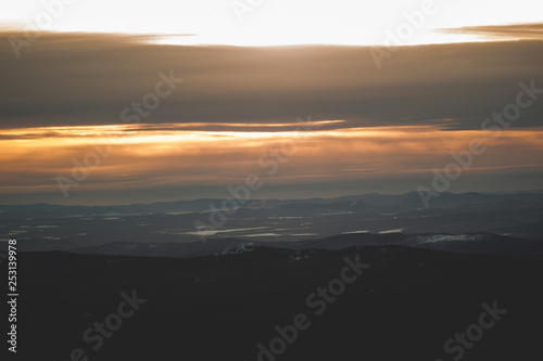 View of the taiga and mountains in the background of sunset during the winter