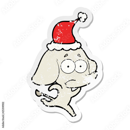 distressed sticker cartoon of a unsure elephant running away wearing santa hat