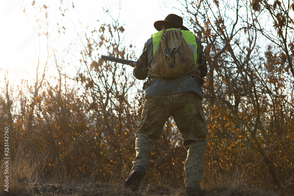 Hunters with a german drathaar and spaniel, pigeon hunting with dogs in reflective vests Hunters with a german drathaar and spaniel, pigeon hunting with dogs in reflective vests
