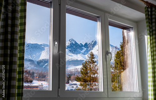 Beautiful  view through window at the Tatry mountains from the hotel in Tatrzanska Lomnica, Slovakia during winter season. photo