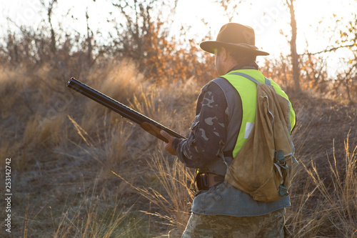 Hunters with a german drathaar and spaniel, pigeon hunting with dogs in reflective vests