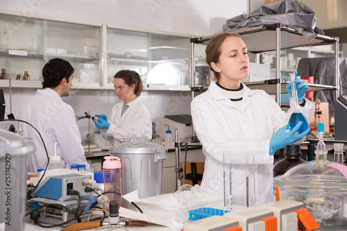 Team of adult chemists working in laboratory