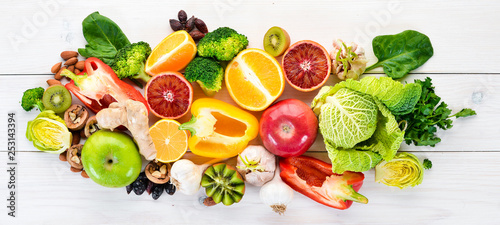 Food containing natural vitamin C: Orange, lemon, apple, rose, garlic, broccoli, apple, kiwi, spinach. Top view. On a white background.