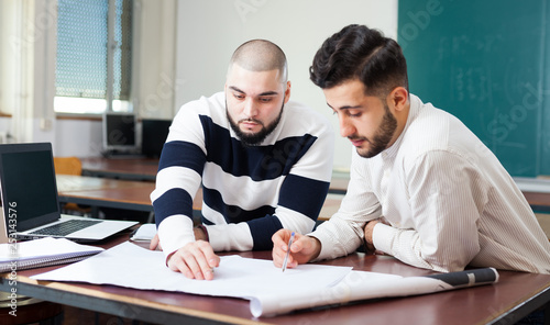 Students working with laptop at desk