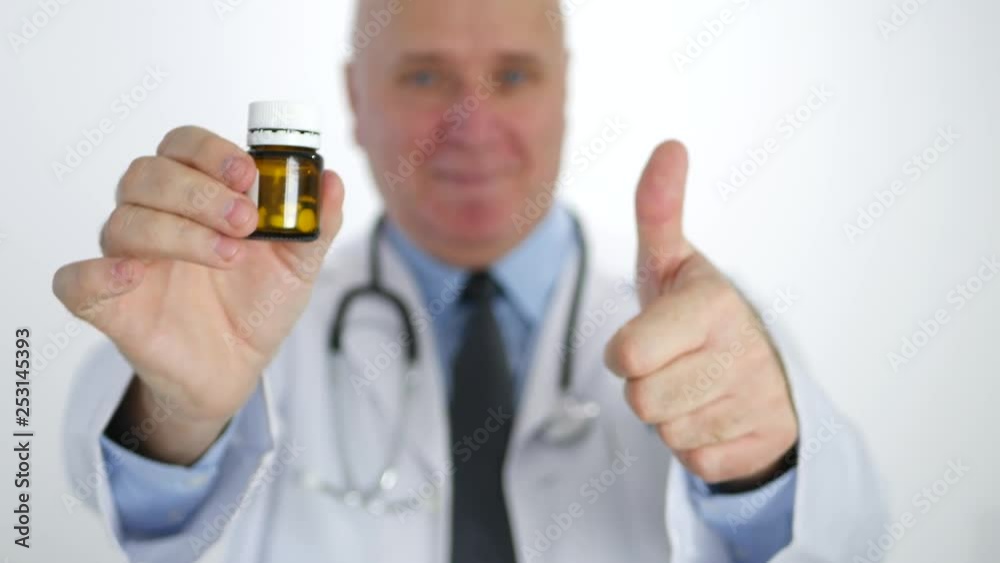 Doctor Smile and Thumbs Up Make Good Job Sign Showing a Recipient with Pills Doctor Smile and Thumbs Up Make Good Job Sign Showing a Recipient with Pills