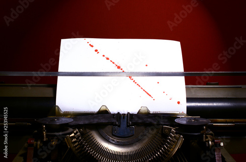 Fotografie Typewriter with blood splashes on paper background