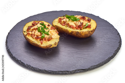 Hot Baked stuffed Potatoes with cheese, bacon, parsley, close-up, isolated on white background