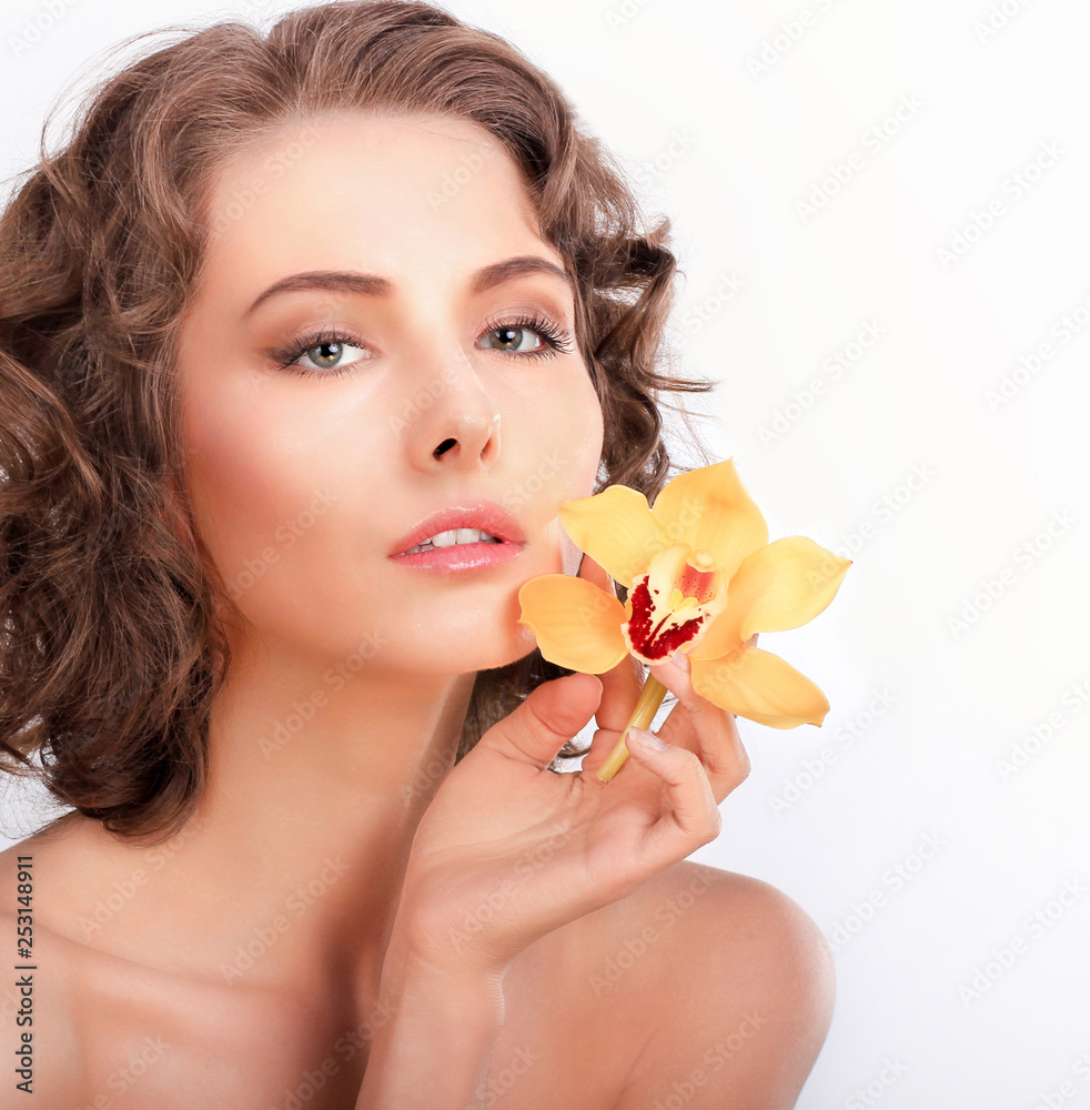 Beauty portrait. Beautiful stylish girl with yellow orchid flower. Isolated on a white background. Beauty portrait. Beautiful stylish girl with yellow orchid flower. Isolated on a white background.