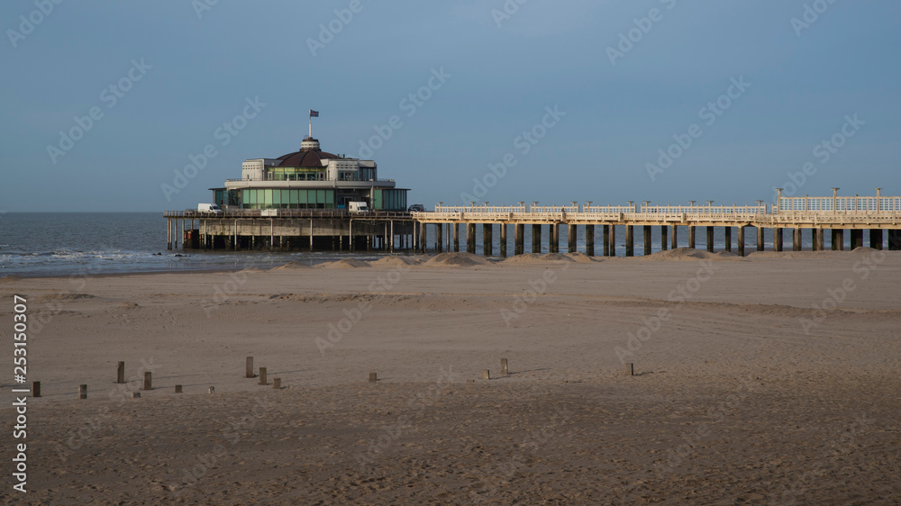 Round building at the end of the pier on a Belgian beach