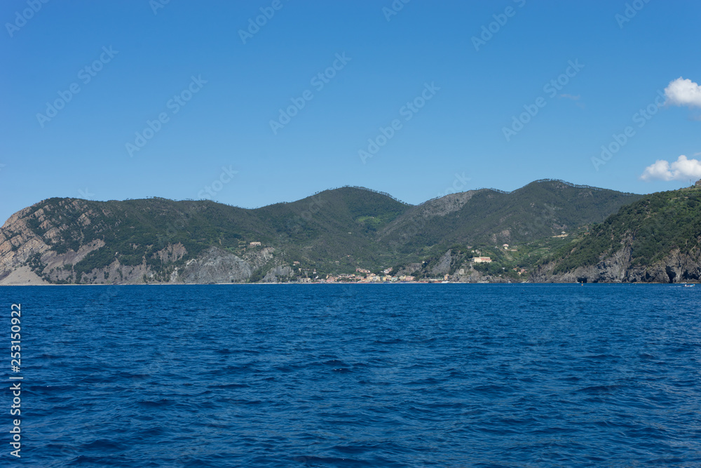 Italy,Cinque Terre,Riomaggiore, a large body of water with a mountain in the background