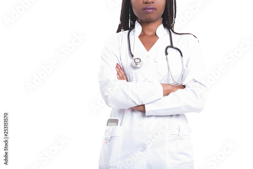Serious Female american african doctor, nurse woman wearing medical coat with stethoscope. Happy excited for success medical worker posing on light background isolated