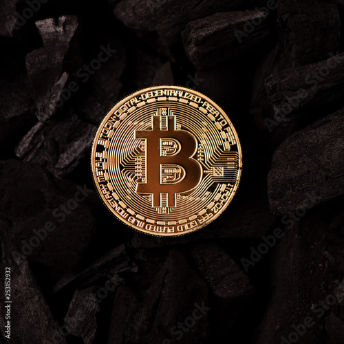 Bitcoin mining concept. Bitcoin cuurency on charcoal photo