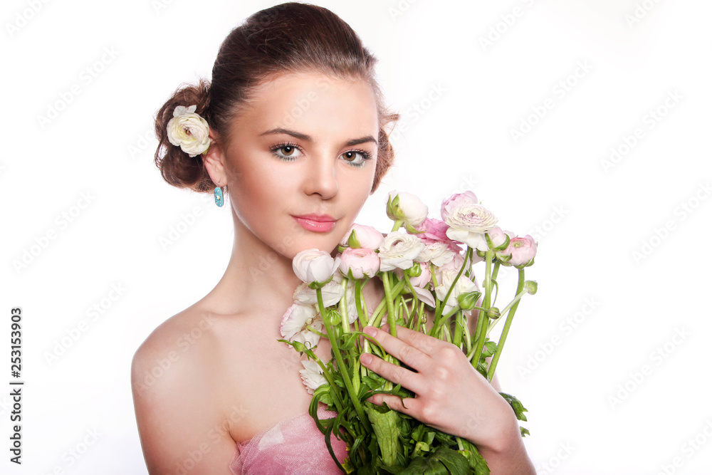 ..Young beautiful woman with a bouquet of tender spring flowers over white background, ranunculus. ..Young beautiful woman with a bouquet of tender spring flowers over white background, ranunculus.