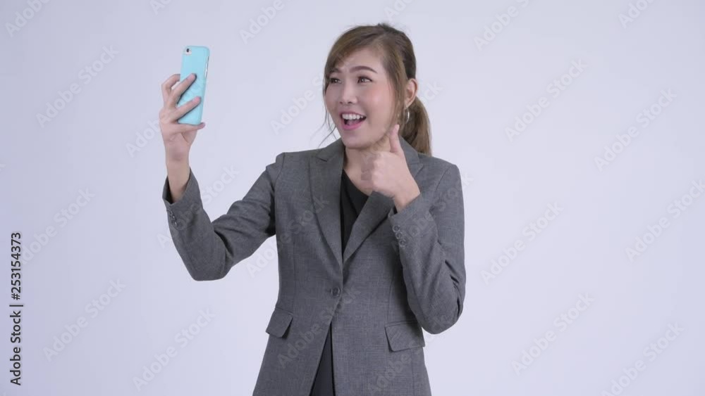 Young happy Asian businesswoman taking selfie Young happy Asian businesswoman taking selfie