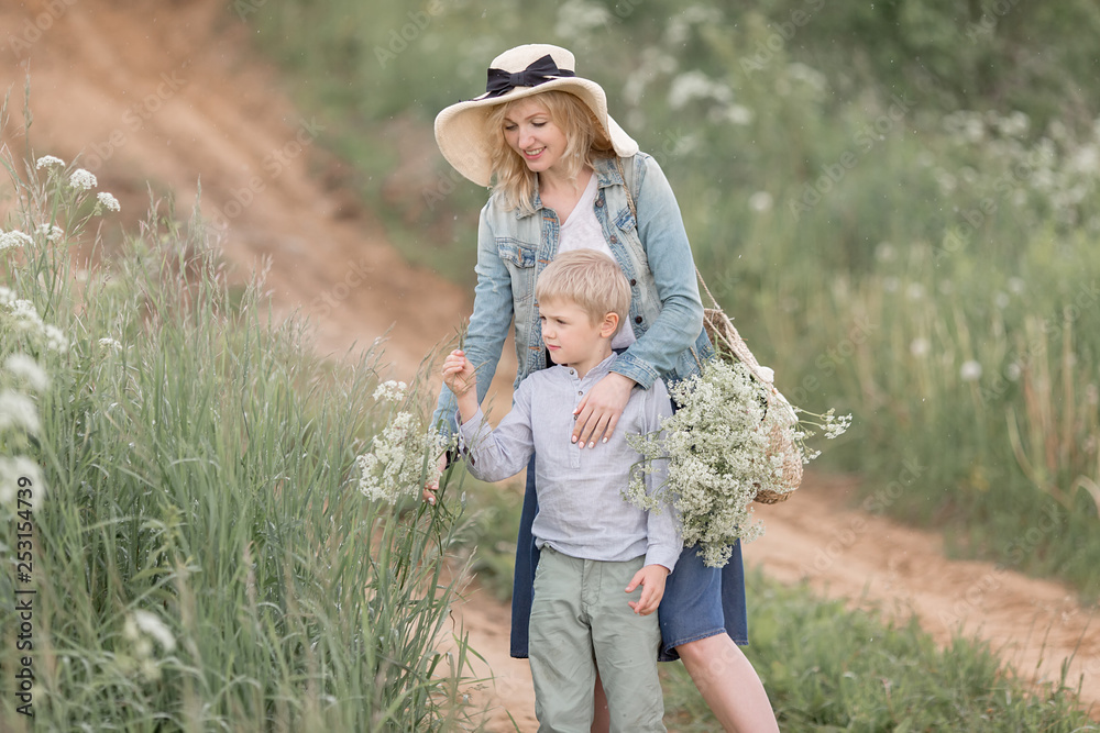Portrait of mother and son happy walking together in the park holding hand. Family concept. Portrait of mother and son happy walking together in the park holding hand. Family concept.