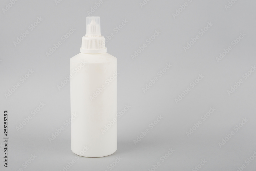 White bottle on a white background. Round white glossy plastic bottle for medical or cosmetic fluid, eye drops, oil. Realistic packaging mockup template. Side view White bottle on a white background. Round white glossy plastic bottle for medical or cosmetic fluid, eye drops, oil. Realistic packaging mockup template. Side view