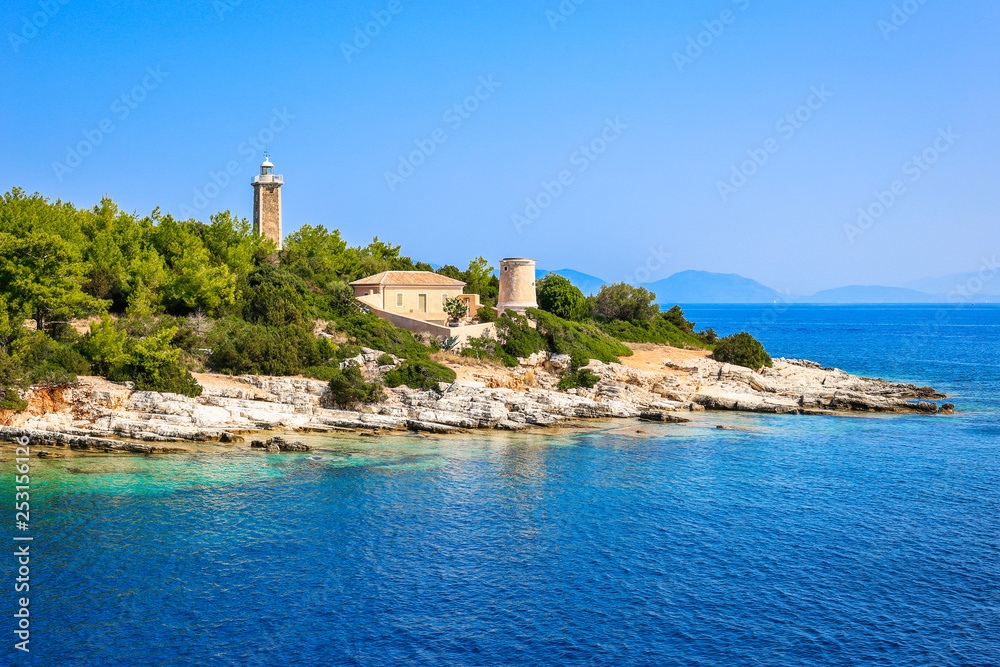 View from the sea on beautiful bay of Fiskardo and old Venetian lighthouse