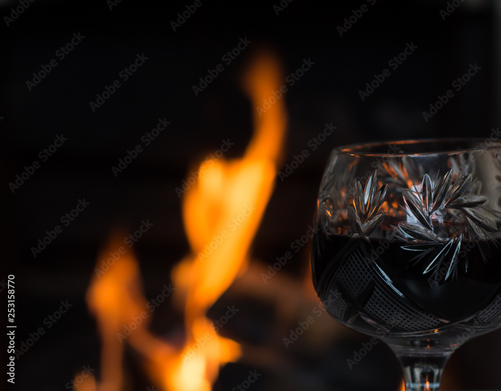 Glass of wine in front of fireplace