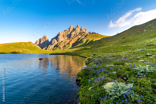 Sunrise light reflections on Tobavarchkhili lake, Egrisi mountains, Svaneti, Georgia photo