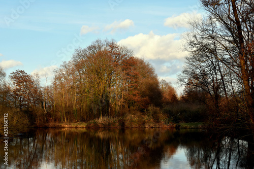 Evening, sunset, river, reflection of clouds in the water, the rays of the sun. River Else.Kirchlenger Germany.