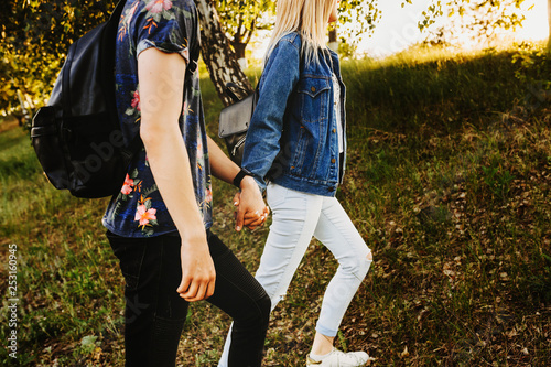 Crop side view of a young lovely couple traveling where woman is leaning his boyfriend on their vacation time photo