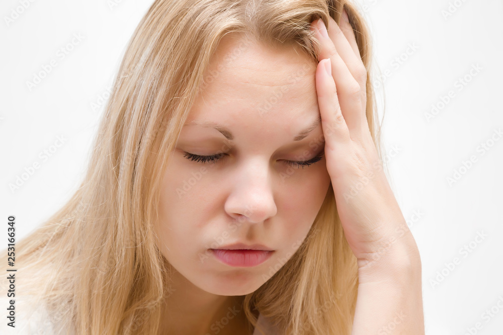 Young, adult blonde lady trying to calm down. Lonely, grieving, nervous woman touching head. Memory disorder. Suffering from burnout or other psychological problems. Women's issues. Face close up. Young, adult blonde lady trying to calm down. Lonely, grieving, nervous woman touching head. Memory disorder. Suffering from burnout or other psychological problems. Women's issues. Face close up.