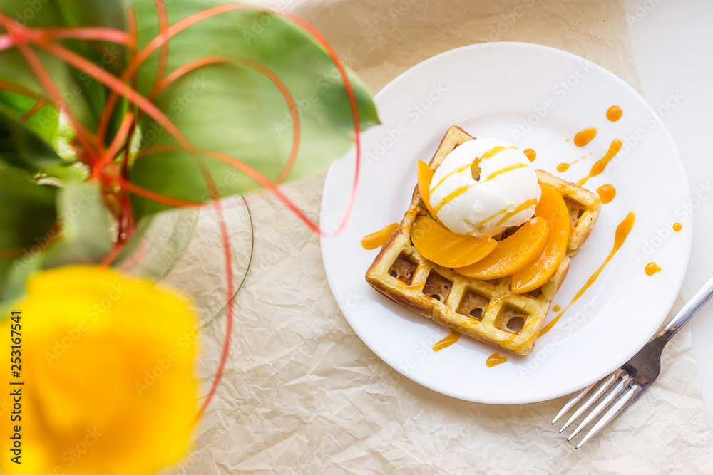 Beautiful festive Belgian waffle breakfast next to a yellow tulip Beautiful festive Belgian waffle breakfast next to a yellow tulip