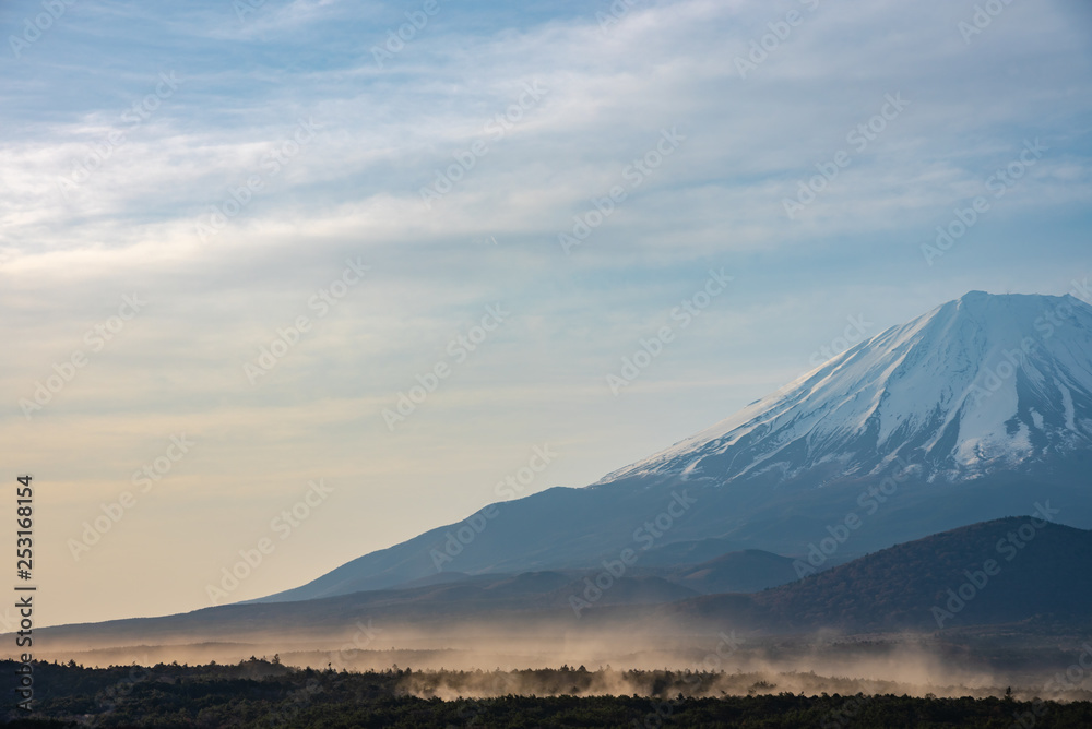 Close up Mount Fuji with natural fine sand flying up in the air. Landscape of The World Heritage. view at Lake Shoji ( Shojiko ) in the morning. Fuji Five Lake region, Minamitsuru, Yamanashi, Japan.