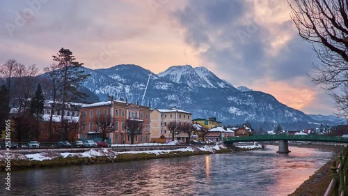 BAD ISCHL, AUSTRIA - FEBRUARY 20, 2019: Watch the sunset above the snowy Katrin Mount from the bank of  Traun river with a view on center of small town in Salzkammergut, on February 20 in Bad Ischl.  photo