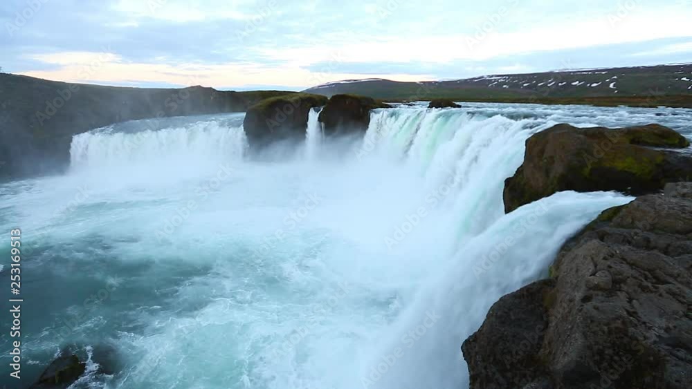 The rapid flow of water powerful Godafoss cascade. Location place Bardardalur valley of Iceland. The rapid flow of water powerful Godafoss cascade. Location place Bardardalur valley of Iceland.