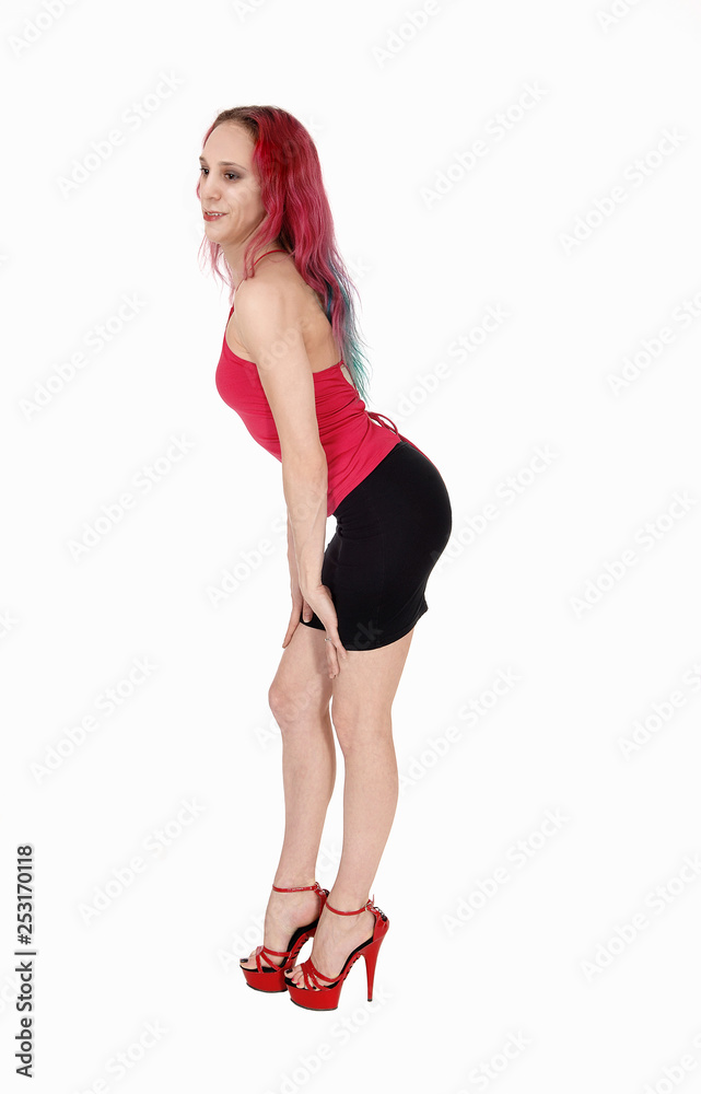 Young woman standing in a black skirt and red blouse bending Young woman standing in a black skirt and red blouse bending