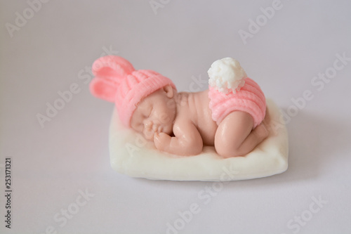 Soap gift in the form of a newborn baby girl on a white background.