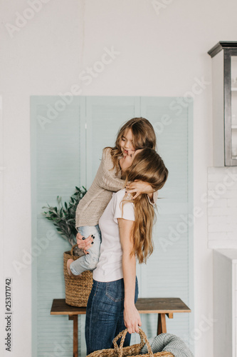 Young mother holding her daughter