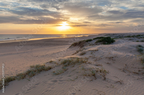 People silhouettes on Birubi beach at sunset. Anna Bay, New South Wales, Australia