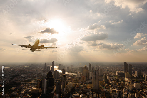 Photography Scene of airplane over city with sun light and light ray over city of Bangkok