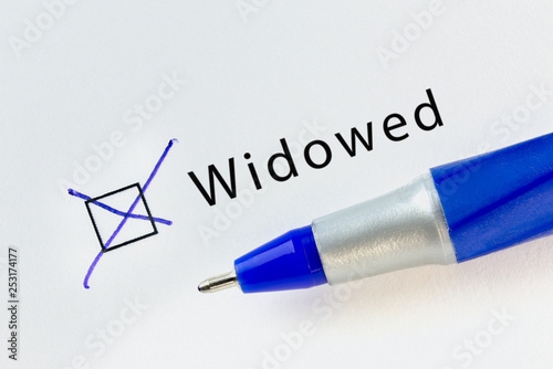 Widowed - checkbox with a cross on white paper with blue pen. Checklist concept photo
