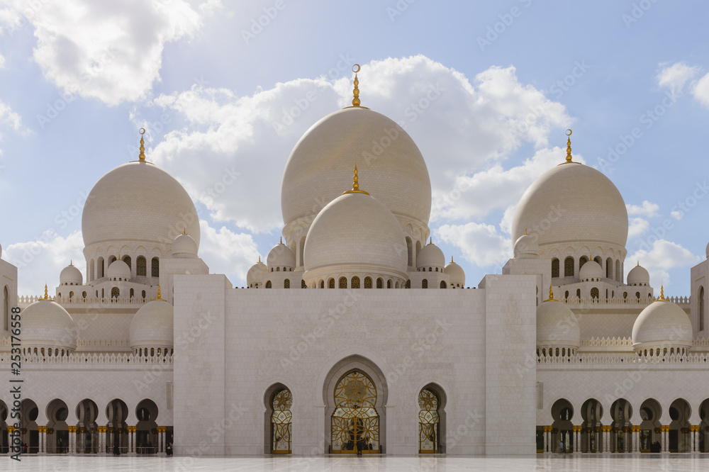 View of the front entrance of the inner courtyard of the white mosque of Abu Dhabi