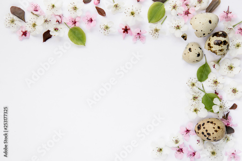 Variety of blossoms pattern composition with quail egg shells on white background. Easter, spring, summer concept. Flat lay, top view
