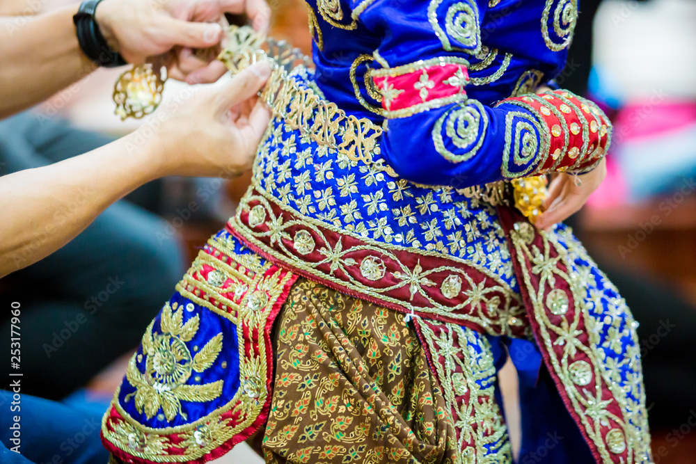The process of dressing the Thai pantomime for the actors with hand sewing, repairing,