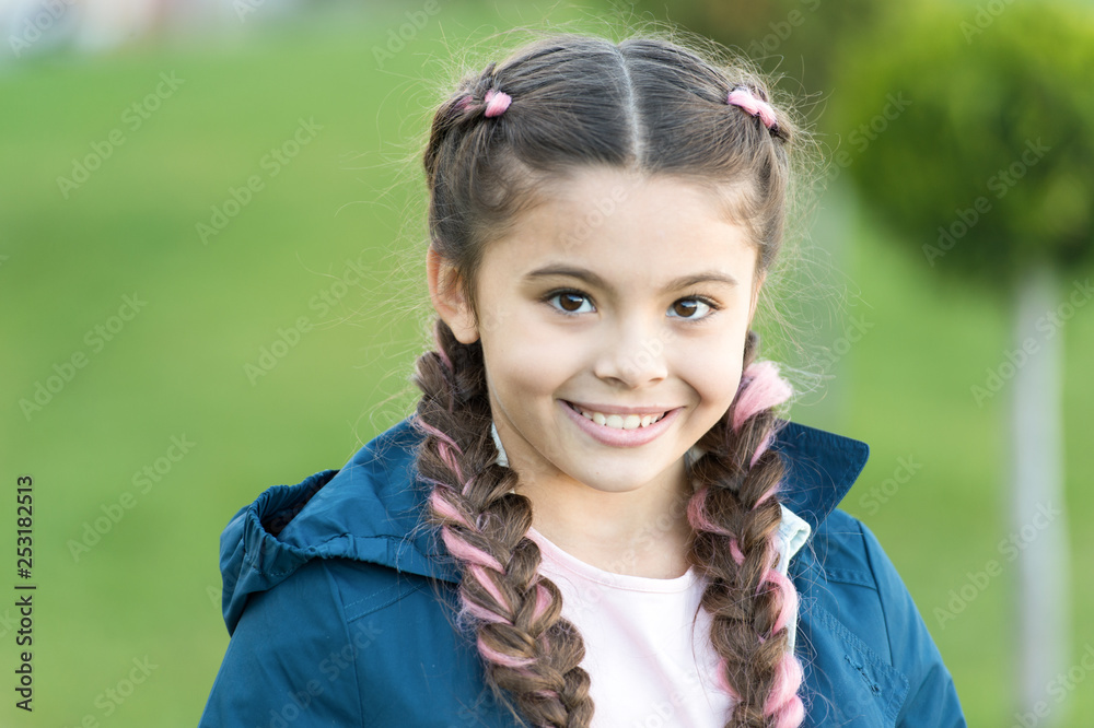 Cute smile. Fashionable hairstyle for kids. Girl small kid with fashionable braids hairstyle. Fashion trend. Salon and hair care. Girl cute smile face outdoors. Pleasant walk in park. Smile and joy Cute smile. Fashionable hairstyle for kids. Girl small kid with fashionable braids hairstyle. Fashion trend. Salon and hair care. Girl cute smile face outdoors. Pleasant walk in park. Smile and joy