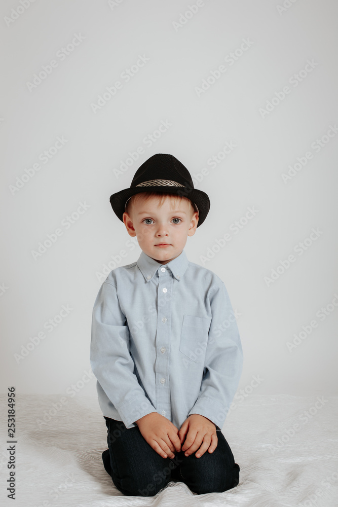 The boy in a black hat and light shirt