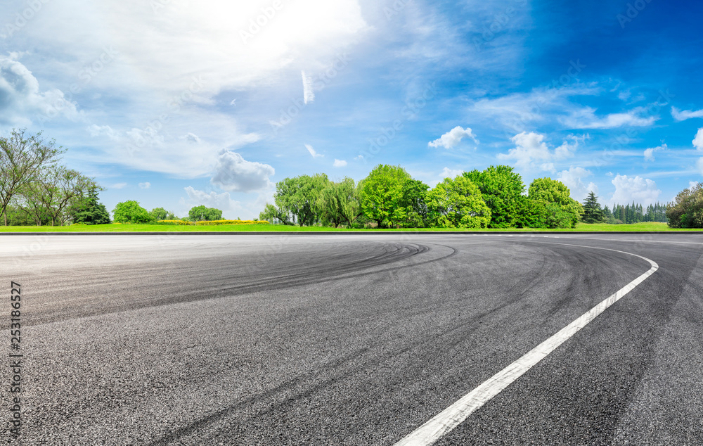 Fototapeta premium Empty asphalt square ground and green forest in summer