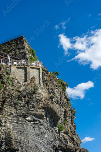 Italy, Cinque Terre, Vernazza, a large stone building with a mountain in the background