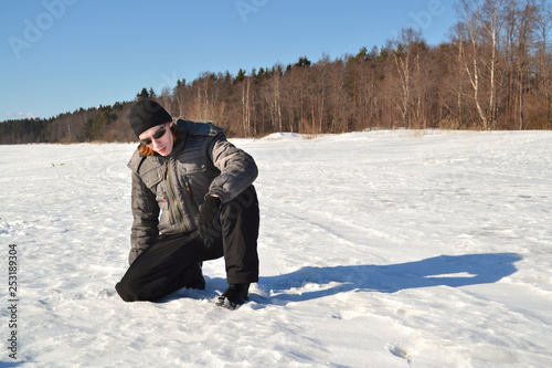 young man in a winter sports suit and sunglasses in the snow © tntk