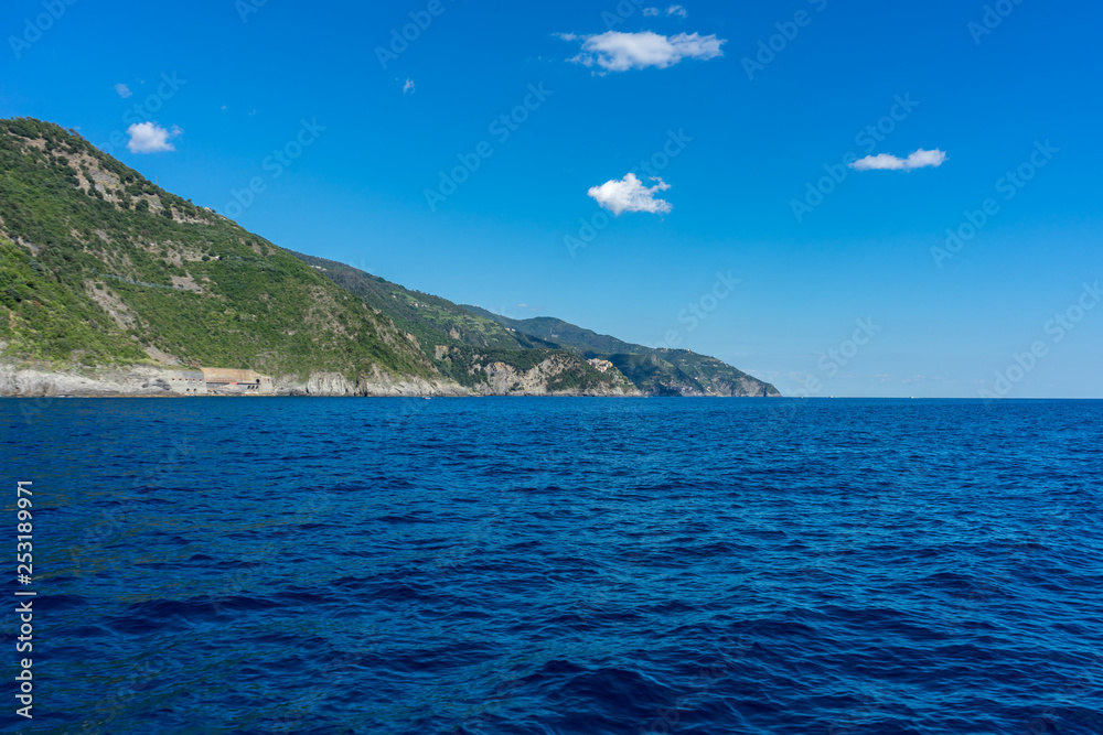 Italy, Cinque Terre, Vernazza, a large body of water with a mountain in the background