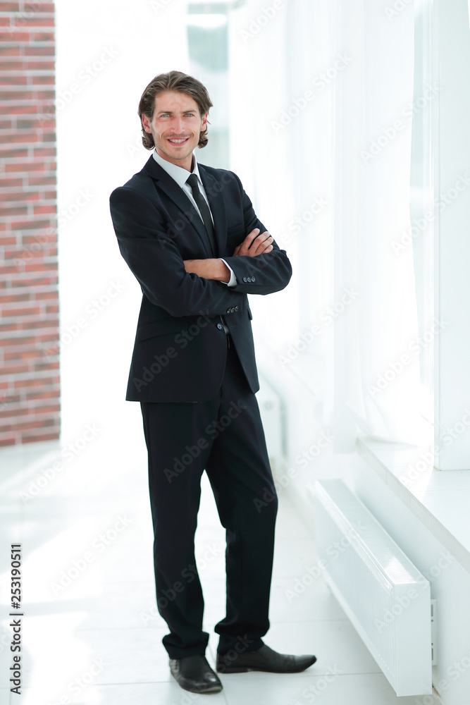 confident business man on background of office. confident business man on background of office.