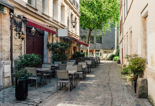 Cozy street with tables of restaurant in Rouen, Normandy, France